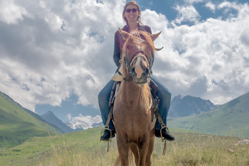 A day riding horseback on the jailoo near the South Shore of Lake Issyk Kul Kyrgyzstan